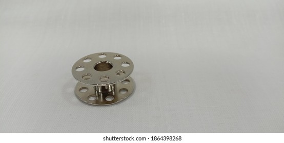 A Metal Bobbin Isolated In White Background