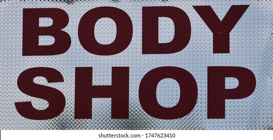 Metal Body Shop Sign With Red And White Text