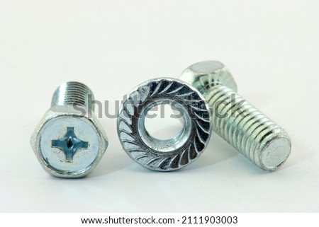 Metal bolts with nuts close-up on a white background.