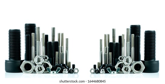 Metal Bolts And Nuts On White Background. Fasteners Equipment. Hardware Tools. Stud Bolt, Hex Nuts, And Hex Head Bolts In Workshop. Threaded Fastener Use In Automotive Engineering. Hexagonal Bolt.