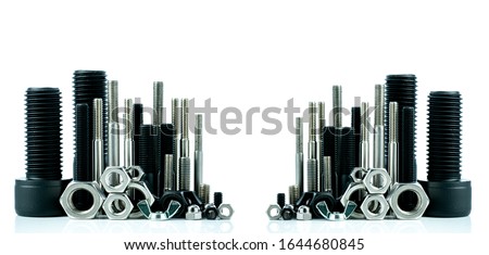 Metal bolts and nuts on white background. Fasteners equipment. Hardware tools. Stud bolt, hex nuts, and hex head bolts in workshop. Threaded fastener use in automotive engineering. Hexagonal bolt.