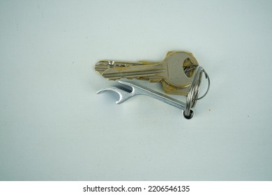 Metal Bottle Opener In The Form Of A Keychain With Attached Steel Split Ring Close-up On A White Background