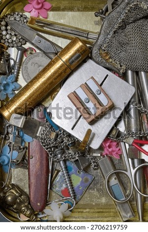 metal box filled with miscellaneous objects seen from above