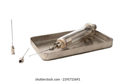 Metal Box Of Old-style Glass Syringe And Spare Needles For The Syringe On White Background. Isolated