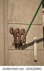 A Metal Bracket For Three Flags Is Attached To The Facade Wall