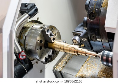 Metal brass workpiece set on spindle chuck of automatic high precision Cnc lathe turning 4 axis machine with function side drill during milling groove by cutting tool in industrial manufacturing  - Powered by Shutterstock