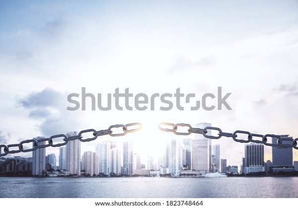 Metal broken chain on panoramic city background.\
Business and challenge\
concept.