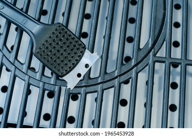 Metal Brush And Scraper For Cleaning The Barbecue Grill. Tool For The Maintenance Of Equipment For Cooking Food On Charcoal Fires. Close-up