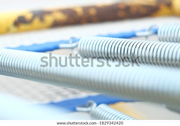 metal cable closeup photo\
for abstract background. Coiled metal spring abstract background\
close up