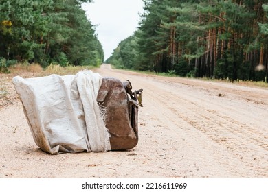 Metal Canister For Fuel On The Road In The Forest