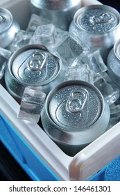 Metal Cans Of Beer With Ice Cubes In Mini Refrigerator, Close Up