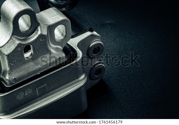 Metal car\
engine spare part on black\
background