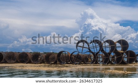 metal casing pipes of large diameter, stacked.  They are used in bridge construction, in particular, for drilling piles in difficult geological conditions, including underwater drilling