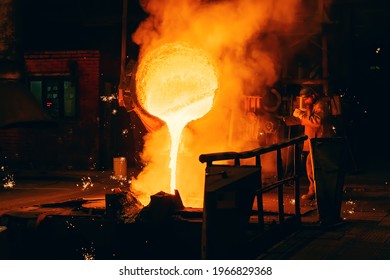 Metal Casting process in Foundry, Molten Iron pours from ladle to Blast Furnace - Powered by Shutterstock