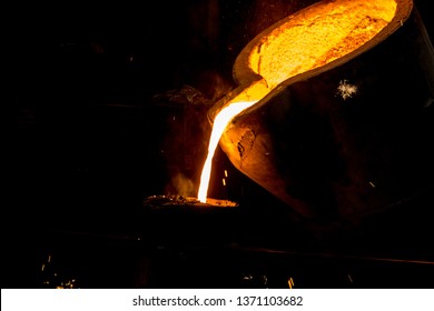 metal casting process with red high temperature fire in metal part factory