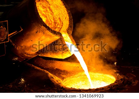 metal casting process with red high temperature fire in metal part factory