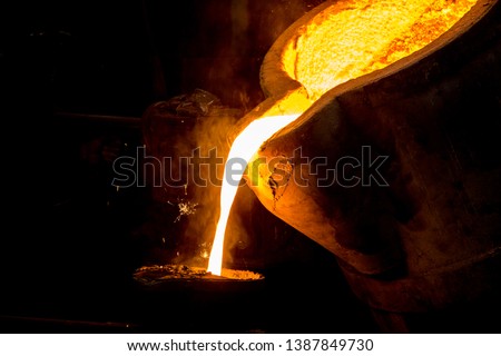 metal casting process with red high temperature fire in metal part factory