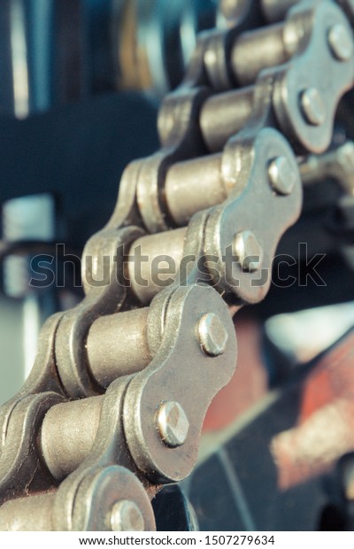 Metal chain in agricultural or industrial\
machinery. Technology\
concept