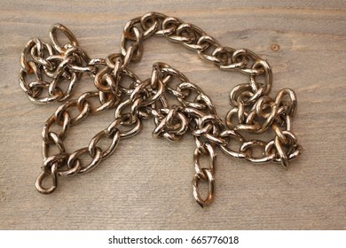 Metal chain on wooden background - Shutterstock ID 665776018