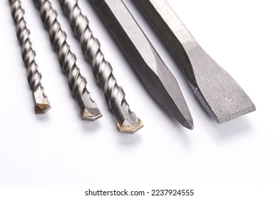 Metal chisel and drill bits on concrete for perforator isolated on white background