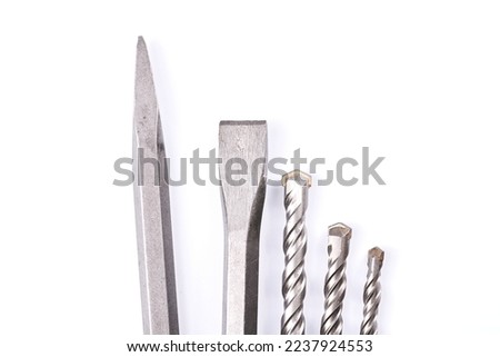 Metal chisel and drill bits on concrete for perforator isolated on white background