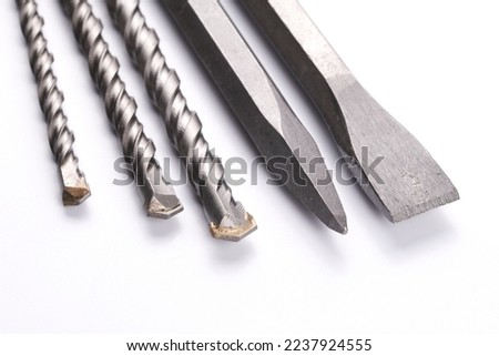 Metal chisel and drill bits on concrete for perforator isolated on white background