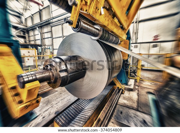 Metal coils machine. Interior of factory.\
Business concept.