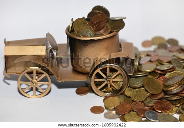 metal coins and an old\
gold colored car