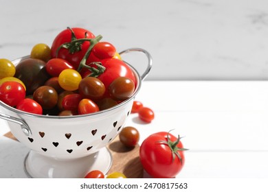 Metal colander with fresh tomatoes on white table, closeup. Space for text - Powered by Shutterstock