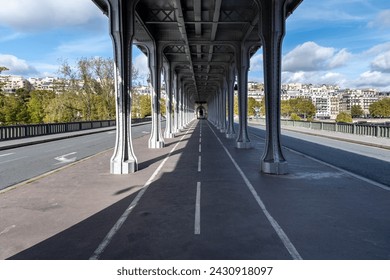 Metal columns and abutments of Bir Hakeim bridge. People walks and make jogging under the bridge in Paris.The bridge is one of the most famous and historic landmark - Powered by Shutterstock