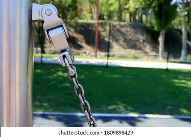 Metal Construction With Bolt And Iron Shiny Thick Chain On Blurred Background . Metal Chain Of A Swing Set Seat In Soft High Key Focus