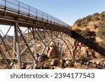 Metal Construction Of Bridge Supports Against Blue Sky And Rocks. Rivets And Braces On Metal Beams. Midgley Bridge, Sedona Arizona. Oak Creek Canyon, Coconino County, High quality photo