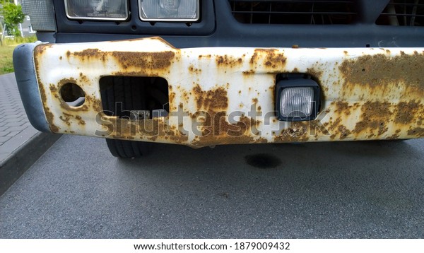 Metal corrosion of old truck. Rust hole removal\
and repair. Rusty messy car surface. Damaged grunge texture from\
road salt. Protecting automobile. Concept of Paint vehicle without\
welding. Service.