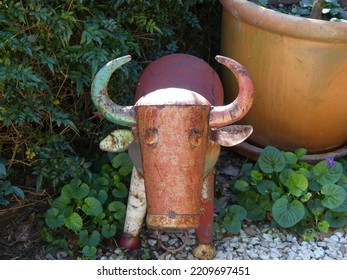 Metal Cow Sculpture In The Garden