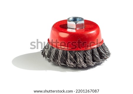 Metal cup brush on a white background. The brush is a cup made of twisted wire. metal brush for a grinding machine on a white background