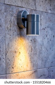 Metal Design Outdoor Spotlight Lamp Lights On A Tiled Wall.