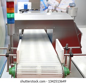 Metal Detector At Conveyor Belt And Stack Lights In Factory