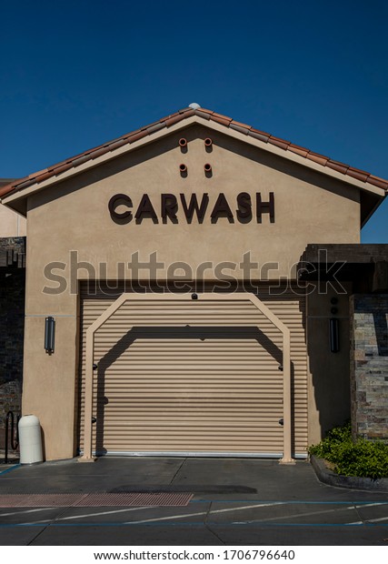 Metal door of carwash business closed during\
peak hours due to Coronavirus\
