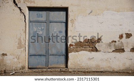 metal door in degraded wall as background