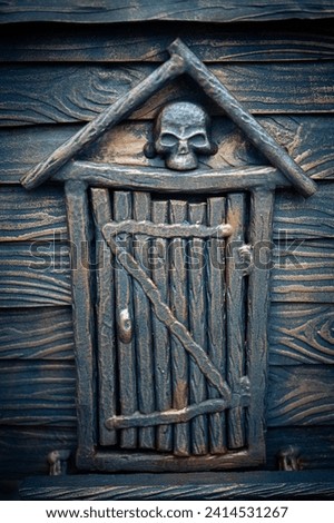 A metal door with a skull on top. Entrance to hell, purgatory. Afterlife concept. Fear of the unknown after death.