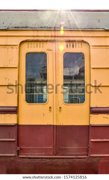 metal doors on the train, orange train doors,\
yellow-red doors