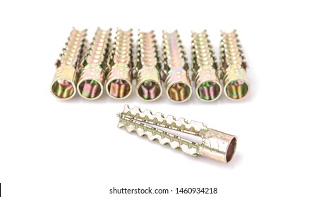 Metal dowels or Metallic expansion anchors with yellow zinc coating screws isolated on white background.