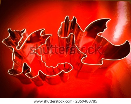 Metal dragon cookie cutters on a red background