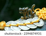 A metal dragon figurine and Chinese coins. Amulets and talismans.