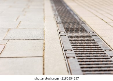 Metal drainage grid on cobblestone - Powered by Shutterstock