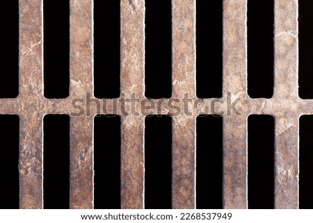 Metal drainage hole support beams pattern. Grunge industrial sewer grate texture. Manhole on concrete drain system cover. Urban sewer background. Metal drain grate texture.