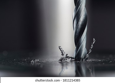 metal drill bit make holes in steel billet on industrial drilling machine. Metal work industry. multi cutting tool and end mill. - Shutterstock ID 1811214385