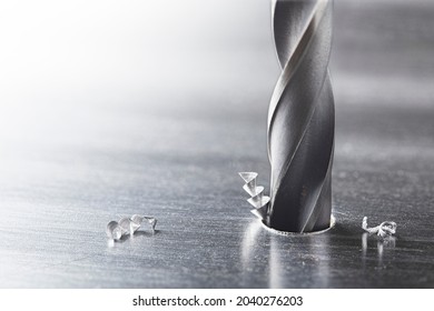 metal drill bit make holes in steel billet on industrial drilling machine. Metal work industry. multi cutting tool and end mill. - Shutterstock ID 2040276203