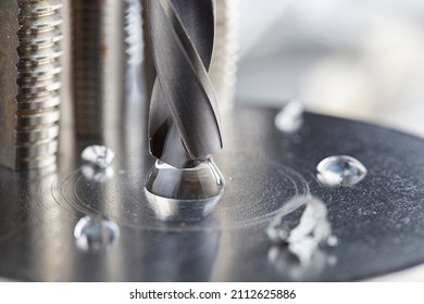 Metal Drill Bit Make Holes In Steel Billet With Tech Oil On Industrial Drilling Machine. Metal Work Industry.