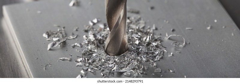 metal drill bit make holes in aluminium plate on industrial drilling machine. Metal work industry. - Powered by Shutterstock